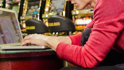 Man using his computer at a casino