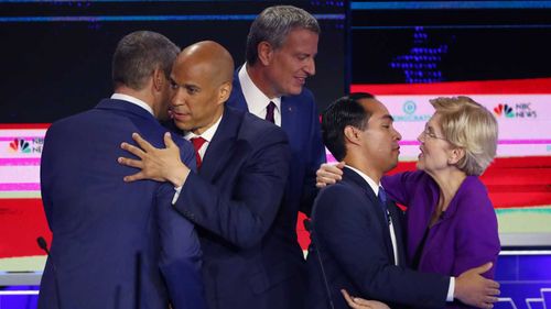 Tim Cory hugs Cory Booker, while Julian Castro embraces Elizabeth Warren at the end of the debate. Bill De Blasio is seen not touching anyone.