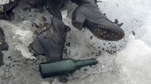Shoes and clothing visible at a Swiss glacier where the bodies of Marcelin and Francine Dumoulin were found 75 years after they disappeared. (AAP)