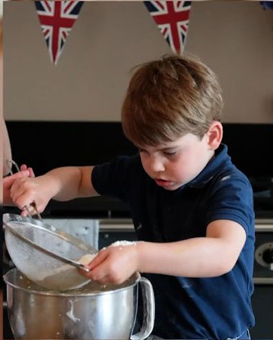 Prince Louis helps sift the flour, with great concentration