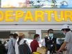 Tourists lines up at a departure gate at Bali airport, Indonesia.
