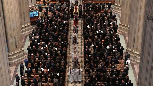 A joint services body bearer team carries the casket with former Vice President Dick Cheney as it proceeds out, following services at the Washington National Cathedral