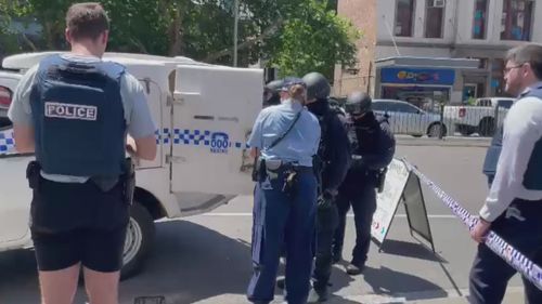 A man has been arrested after he allegedly refused to leave a hotel room in Sydney's central business district this afternoon while allegedly armed. 