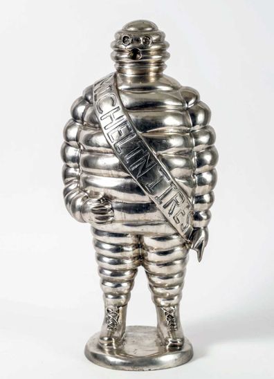 A silver and bronze sculpture of the Michelin man that was owned by Anthony Bourdain