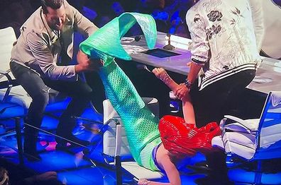 Katy Perry falls off her chair while dressed as the Little Mermaid on American Idol 