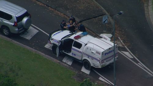 A man appears to have taken a selfie during an arrest after a police pursuit down Queensland's Bruce Highway.