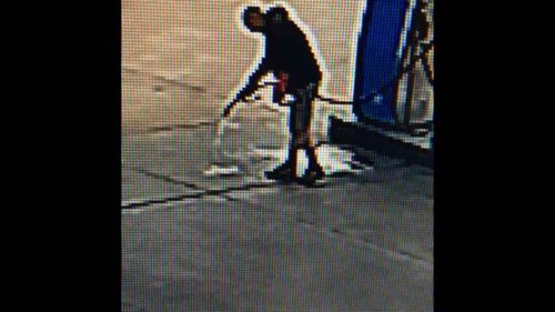 CCTV footage shows petrol being hosed onto the service station driveway.