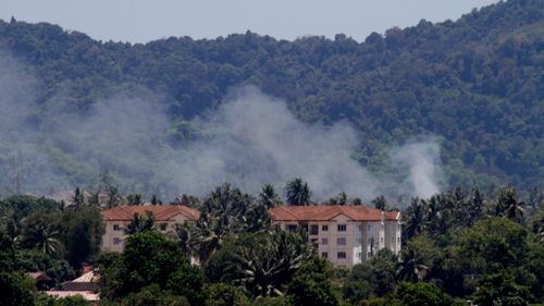 Smoke rises after the crash in Langkawi, Malaysia. (AAP)