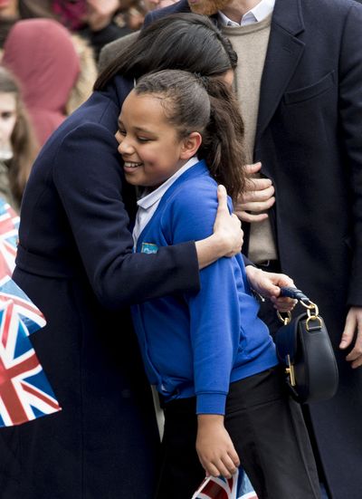 Meghan embraces a fan in Birmingham, England