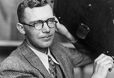 Discovered by Clyde Tombaugh in 1930, when was Pluto reclassified a dwarf planet?