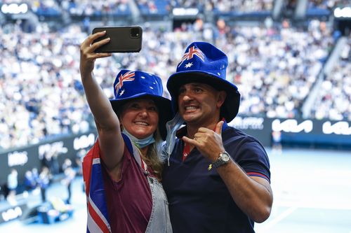 Spectators pose for a selfie during the Womens Singles Final match between Ashleigh Barty of Australia and Danielle Collins of United States