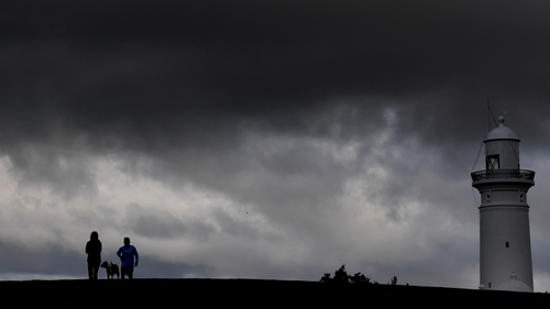 Pedestrians are seen walking in the Lighthouse Reserve, near Vaucluse, in Sydney Saturday, 5 October 2019. Sydney is experiencing a dramatic drop in temperatures over the weekend as a cold front moves in from the state's south