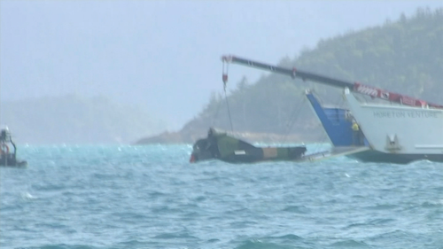 The wreckage the Taipan is removed from waters in the Whitsundays after the crash last year.