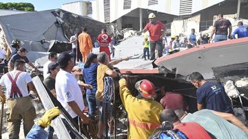 Rescue workers search for survivors amid debris after the roof of a church collapsed