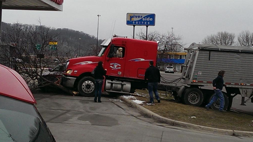Dog takes the wheel of a semi-trailer, crashes into parked car