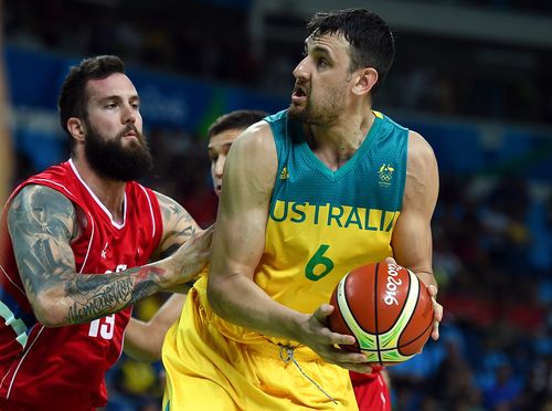 Miroslav Raduljica of Serbia (left) looks to take possession off Andrew Bogut (right) during the Men's Basketball Semifinal between Australia and Serbia in 2016. (AAP)