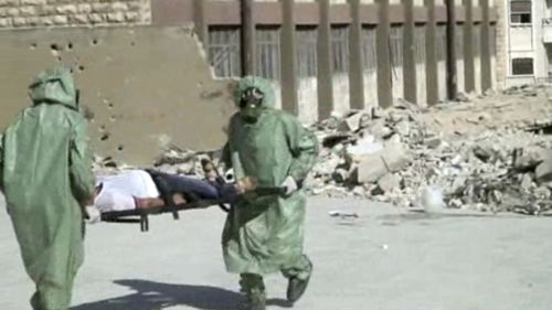 Syrians in protective suits and gas masks conduct a drill on how to treat casualties of a chemical weapons attack in Aleppo in September, 2013. (AP)