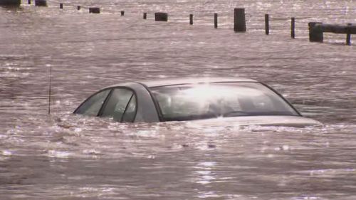 Two men have been pulled from a car trapped in floodwater at East Gippsland in Victoria. 