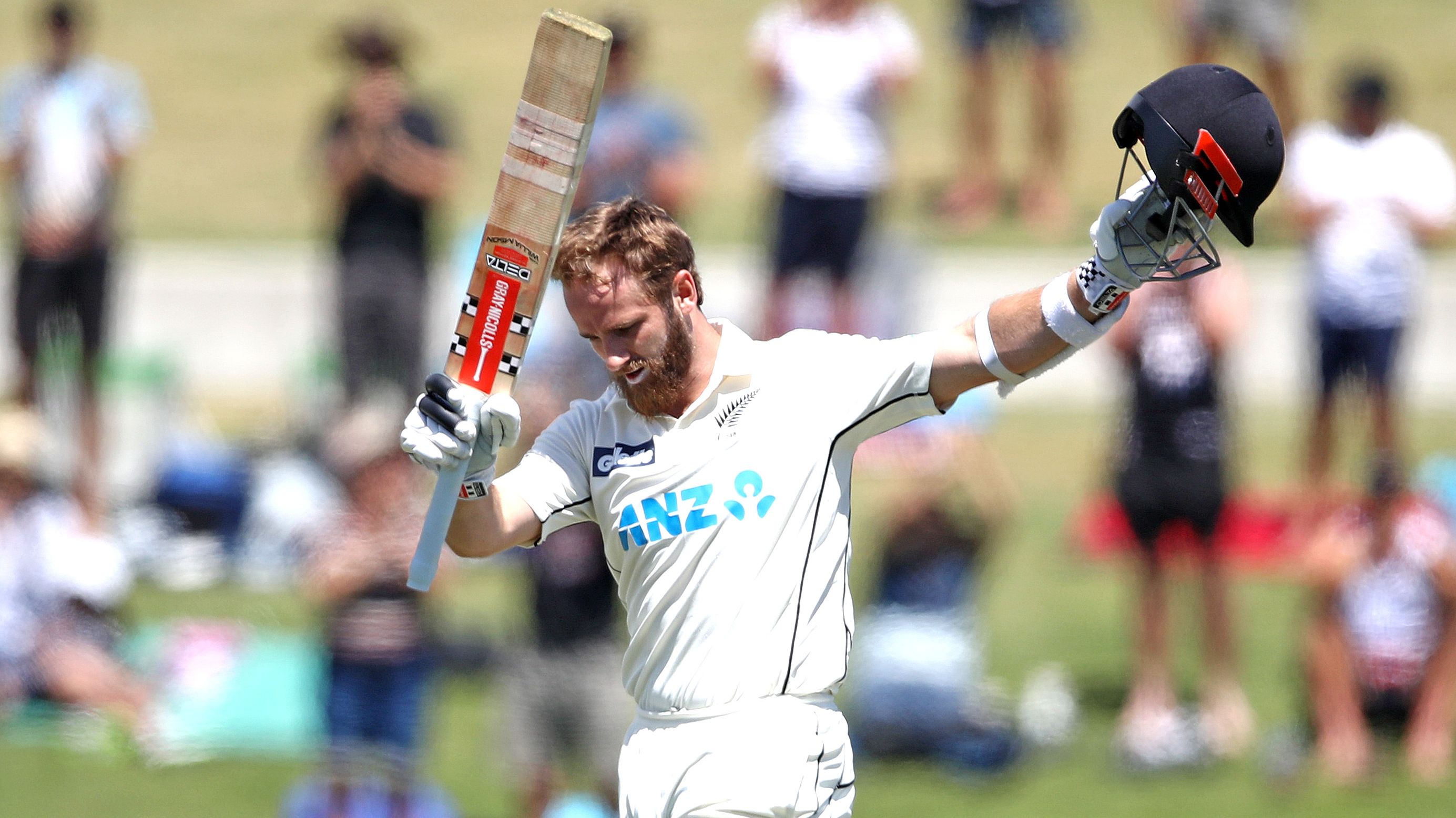 Kane Williamson of New Zealand acknowledges applause for his century.