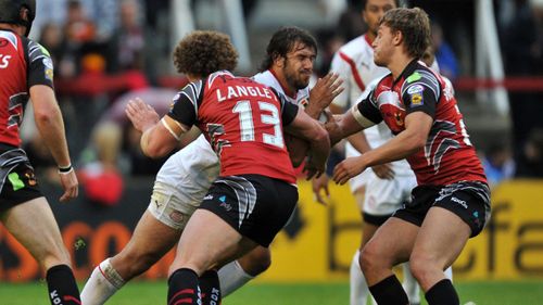 St Helens' Scott Moore is tackled by Bradfords Jamie Langley and Elliot Whitehead during a match at St Helens in 2010. (AAP)
