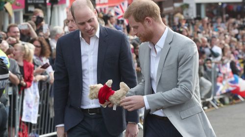 Harry was given a teddy bear by a member of the crowd. (Getty)