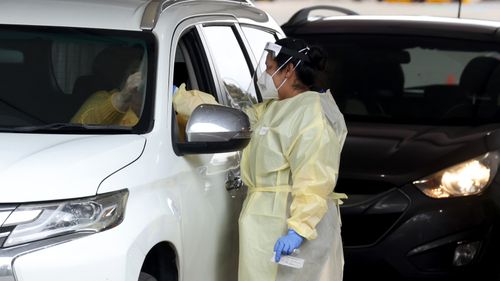 Health workers are seen at the pop up Covid-19 testing site at Waterworld in Ridgehaven on July 21, 2021 in Adelaide.