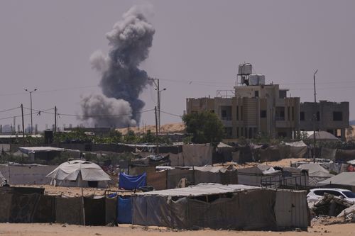 Smoke rises to the sky following an Israeli army airstrike in Khan Younis, southern Gaza Strip, Saturday, July 19, 2025. (AP Photo/Abdel Kareem Hana)