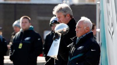 Philadelphia Eagles owner Jeffrey Lurie holds the Vince Lombardi trophy with head coach Doug Pederson, behind left. (AAP)