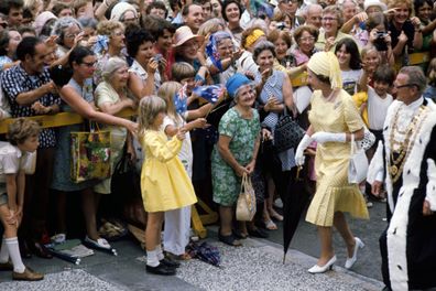 Queen Elizabeth II, carrying her own umbrella, is accompanied by the Lord Mayor of Brisbane, Alderman Frank Sleeman, as she goes walkabout in the streets of Brisbane, during her Silver Jubilee tour of Australia.   (Photo by Ron Bell/PA Images via Getty Images)