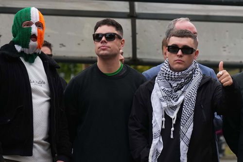 Liam Óg Ó hAnnaidh, aka Mo Chara, right, a member of the Irish language band Kneecap, celebrates as he leaves Woolwich Crown Court in London, Friday, Sept. 26, 2025, after Chief Magistrate, Senior District Judge Paul Goldspring, dismissed a terrorism offence relating to displaying a flag in support of Hezbollah during a performance with the band in November 2024, on a technical error. 