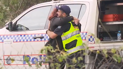 Queensland Police officer David Masters killed by car while laying road spikes to stop allegedly stolen car.