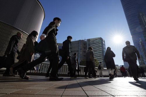 Commuters walk in a passageway during a rush hour at Shinagawa Station Wednesday, Feb. 14, 2024, in Tokyo. Japan has slipped to the worlds fourth-largest economy as government data released Thursday, Feb. 15, showed it fell behind the size of Germany's in 2023. (AP Photo/Eugene Hoshiko)