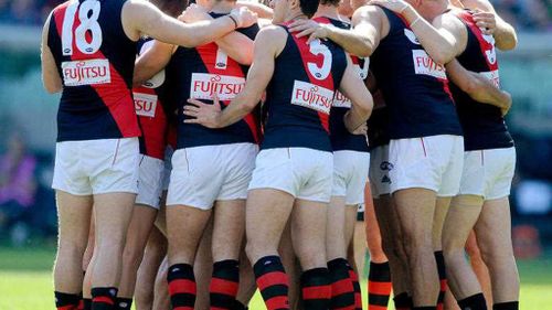 Essendon players in a huddle. (AAP)