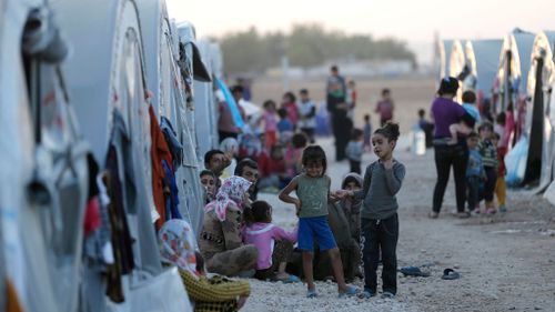 Syrian refugees are seen at a refugee camp after they fled from ISIL violence. (AAP)