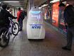 Commuters pause to look at the NYPD&#x27;s Knightscope K5 autonomous security robot at the Times Square subway station in New York City.