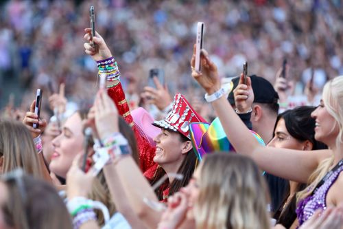 Fans watch as Taylor Swift performs on stage at Melbourne Cricket Ground on February 16, 2024 in Melbourne, Australia.  