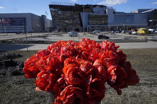 Flowers lie in front of the Crocus City Hall on the western outskirts of Moscow, Russia, Wednesday, March 27, 2024.  