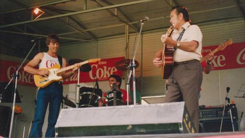 Gary Brown with his father Geoff on stage.