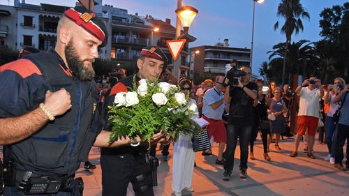 Thousands of people hold sign-boards and posters in Tarragona, Spain on August 25, 2017 to demonstrate against terrorism and the recent attacks in Barcelona. (AAP)