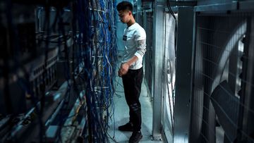 A worker adjusts cryptocurrency mining rigs at a cryptocurrency farm in Dujiangyan in China&#x27;s southwestern Sichuan province.