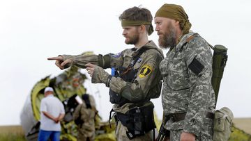 Pro-Russian separatist soldiers have been accused of looting the crash site of downed plane MH17. (AAP)