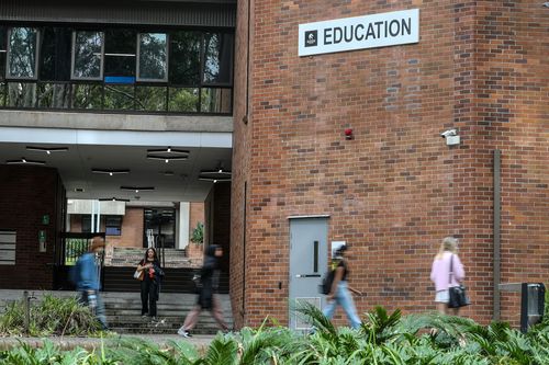 NEWCASTLE, AUSTRALIA - MARCH 24: People walk at the University of Newcastle's Callaghan campus on March 24, 2025 in Newcastle, Australia. The upcoming Australian Federal Budget for 2025-26, set to be presented by the Albanese government on March 25, 2025, is expected to focus on key areas such as healthcare, green energy, and manufacturing, with significant investments aimed at enhancing these sectors. The budget will also include measures to support cost-of-living relief, education reforms, and