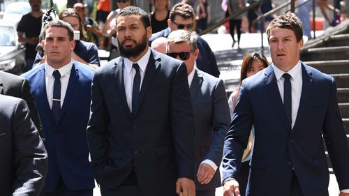 Elliott and Fine (Left and second from the left, respectively) leave the Downing Centre in Sydney accompanied by their team captain Josh Jackson.