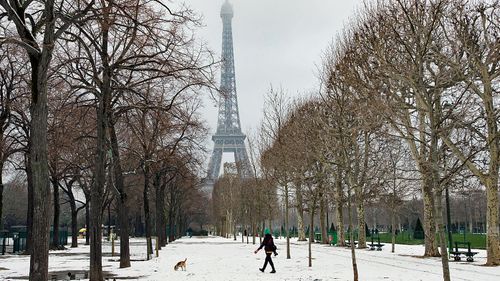 The Eiffel Tower is closed to visitors after heavy snow covered the wrought iron structure. (Photo: AP).