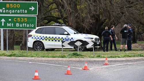 Police at the scene in Porepunkah, where two officers were shot dead and another injured while serving a warrant.