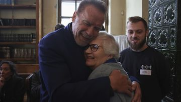 Arnold Schwarzenegger, left, hugs Holocaust survivor Lydia Maksimovicz, right, in Oswiecim, Poland, Wednesday, Sept. 28, 2022.  