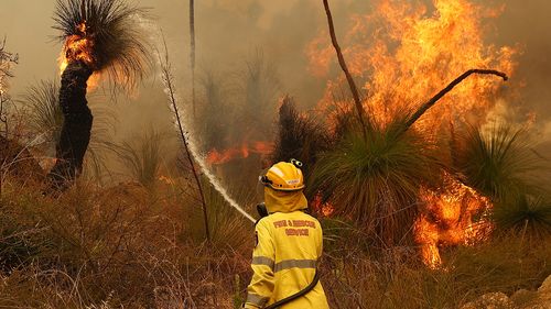 Fire crews control bush fires as they approach properties on Copley Road in Upper Swan on February 02, 2021 in Perth, Australia.