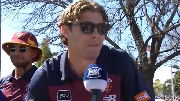 Brisbane Lions player Deven Robertson is interviewed during the AFL grand final parade.