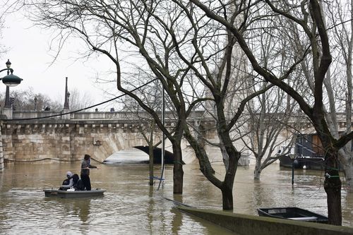 Some river-side restaurants are underwater and the bottom level of the Louvre has been closed. (AAP) 