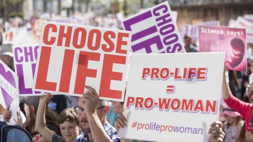 Protesters hold placards during a pro-life rally in Brisbane last month.